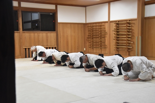 Aikido practitioners bowing at the dojo